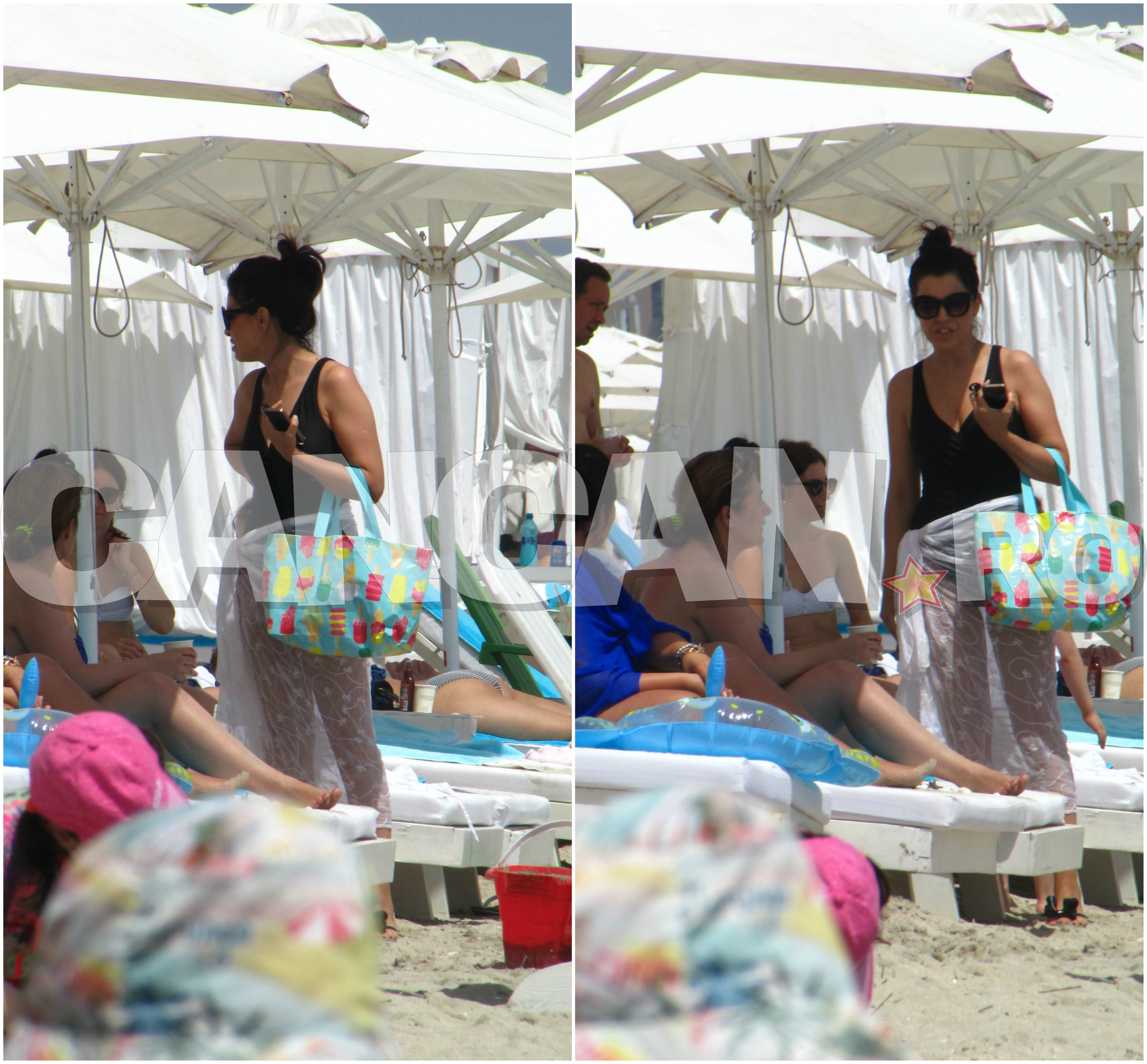 Vedeta îşi acoperă formele cu un pareo, deşi este pe plajă.