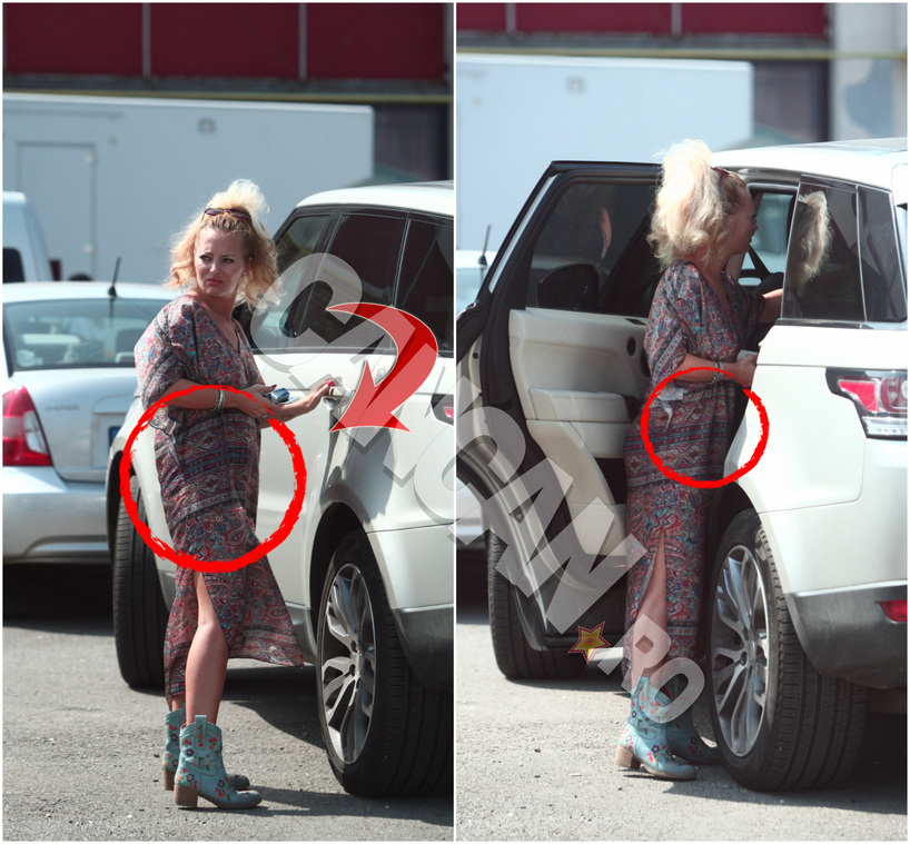 Cu toate că a tot negat că ar aştepta un copil, fotografiile CANCAN.ro îi arată Deliei burtica pe care parcă o ascunde sub rochie.