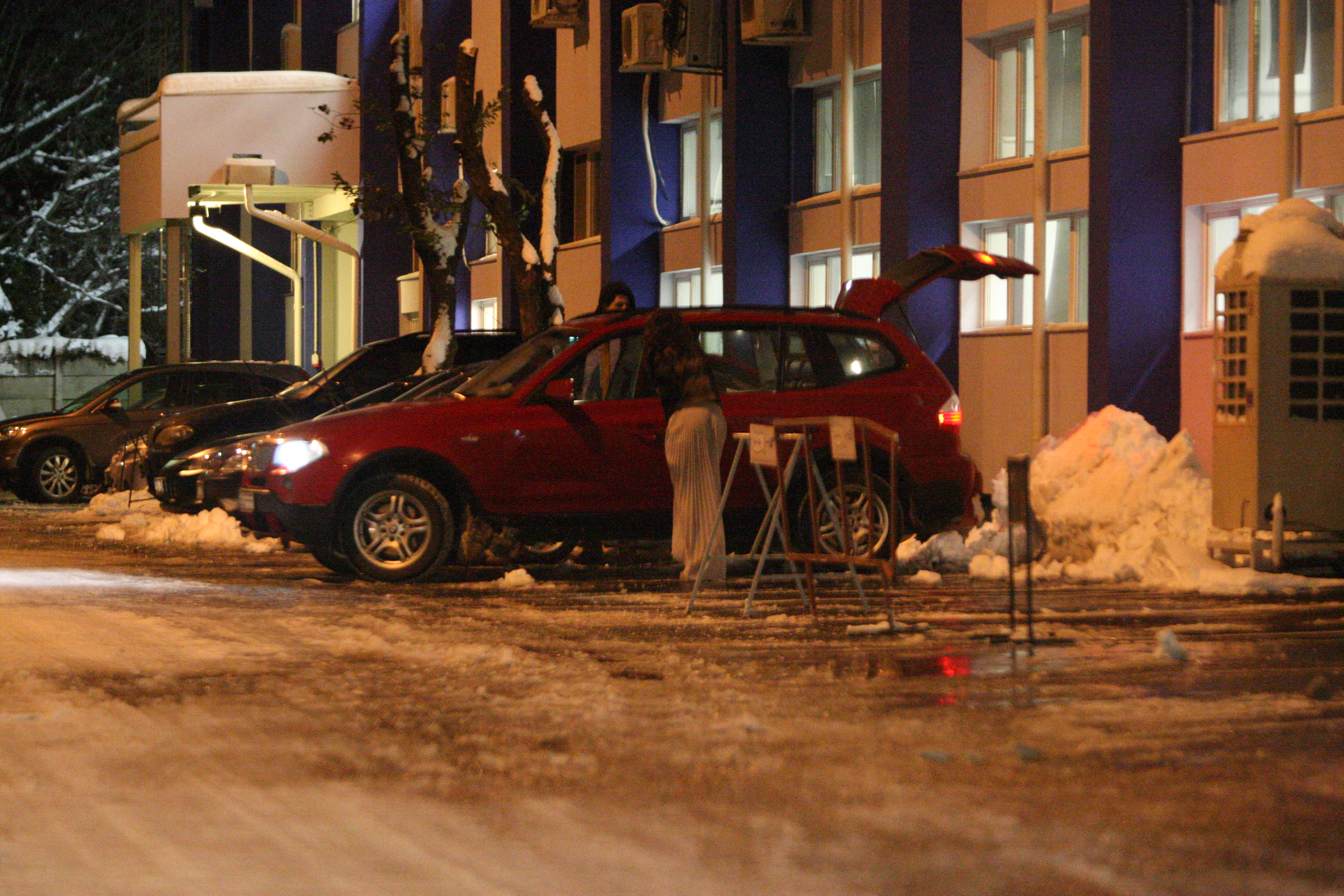 Satena se sprijina de masina si incearca sa urce in autoturism