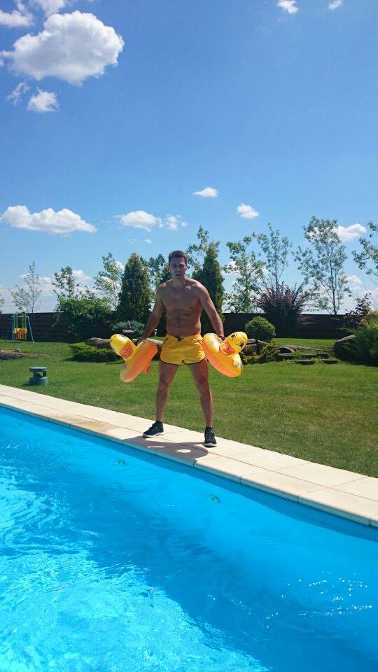 Mircea Badea s-a lasat fotografiat pe marginea unei piscine, in timp ce tinea in mana doua colace de inot cu ratuste