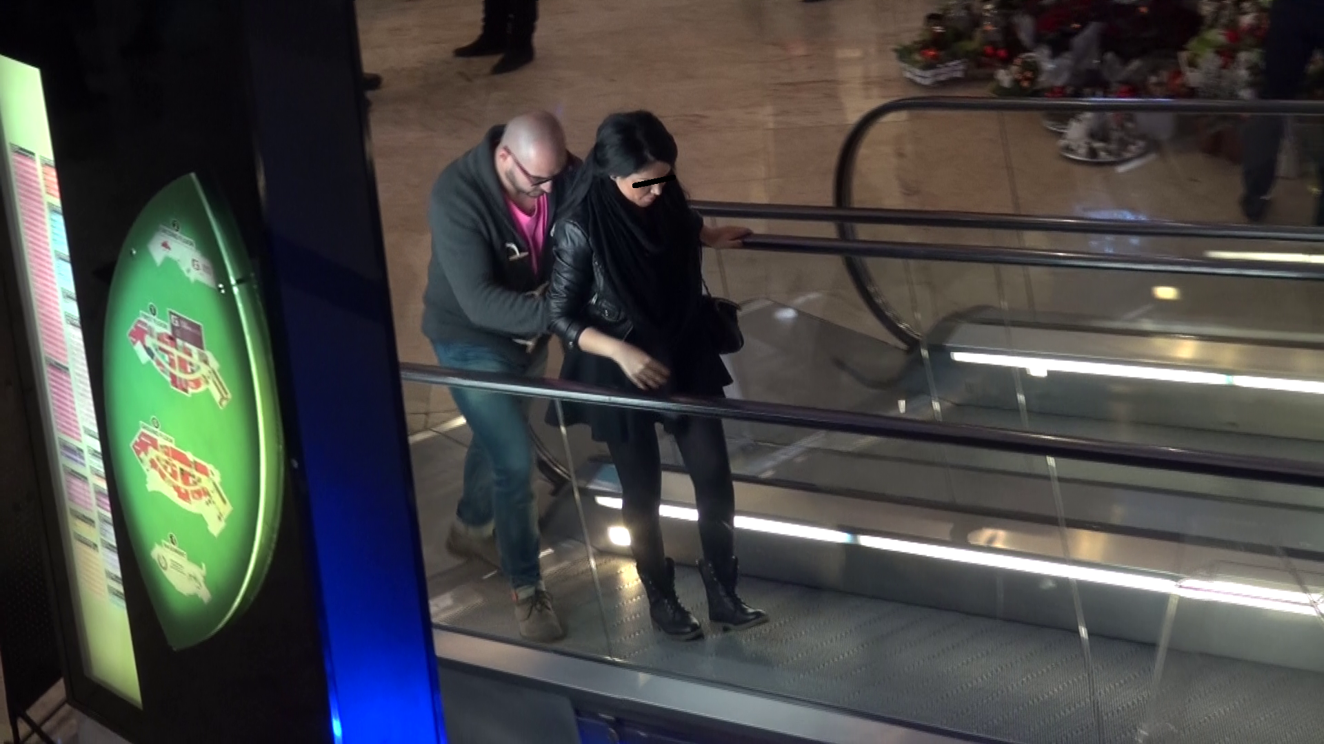 Luptatorul o ajuta sa urce pe scarile rulante