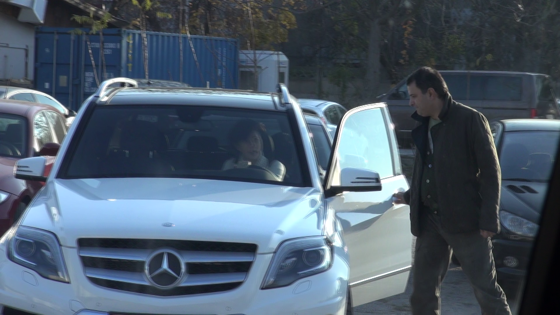 Mandruta ii deschide Ioanei portiera si astepta sa se urce la volan ca sa inchida usa.