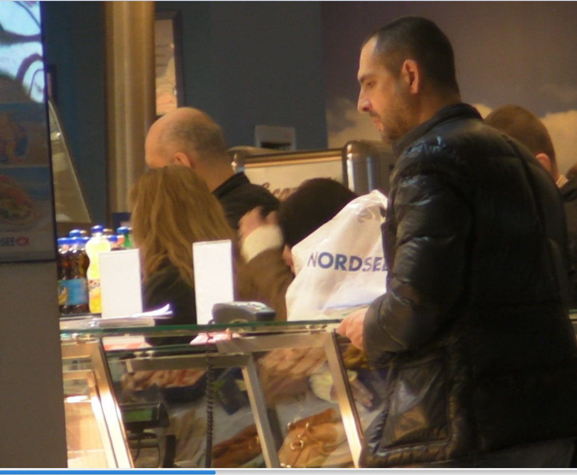 Madalin Ionescu se uita la ce mancare ii ambaleaza vanzatoarea, ca nu cumva sa ii incurce comanda