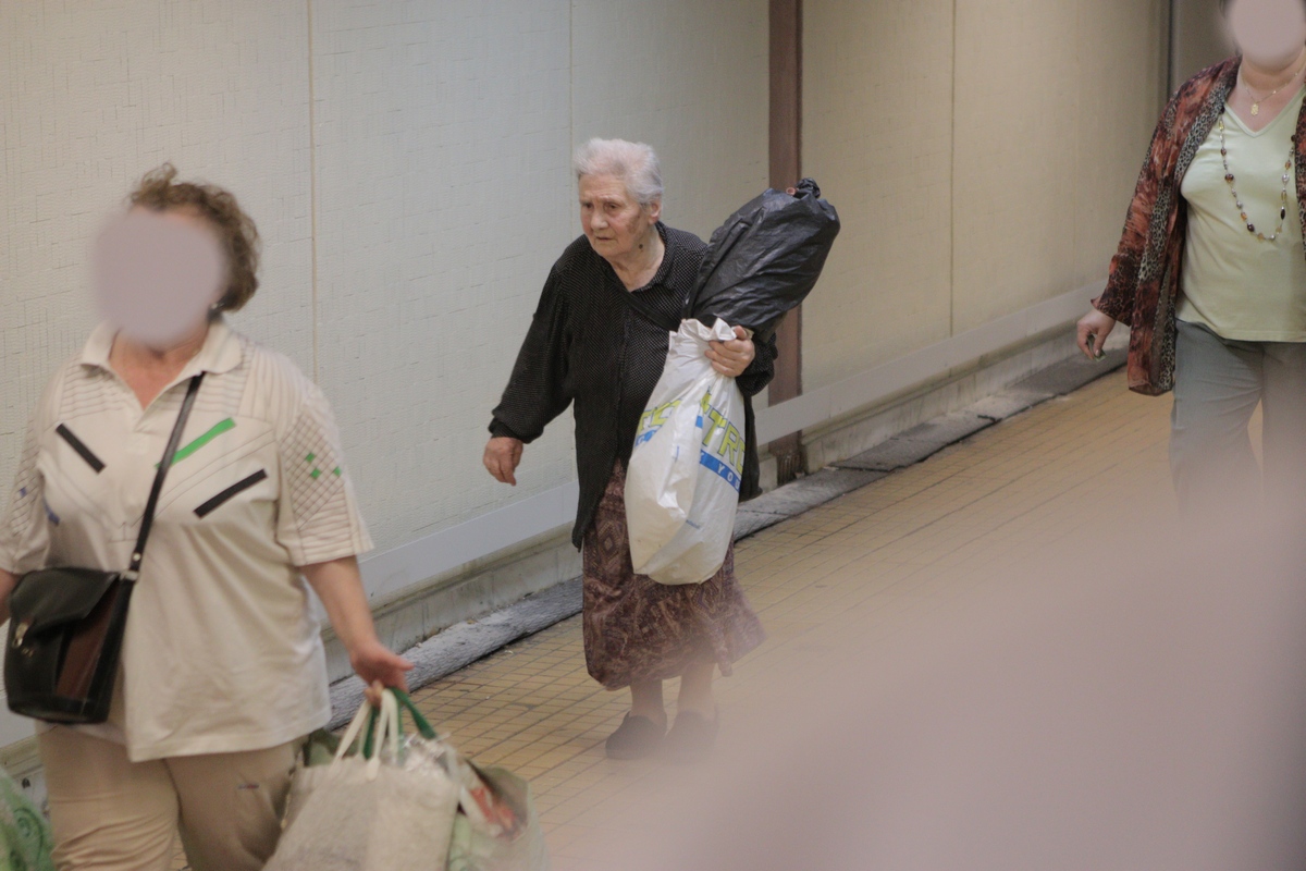 Simpatica bunicuta a fost ajutata de o vecina, deoarece nu isi poate cara siungura toata sacosele cu flori