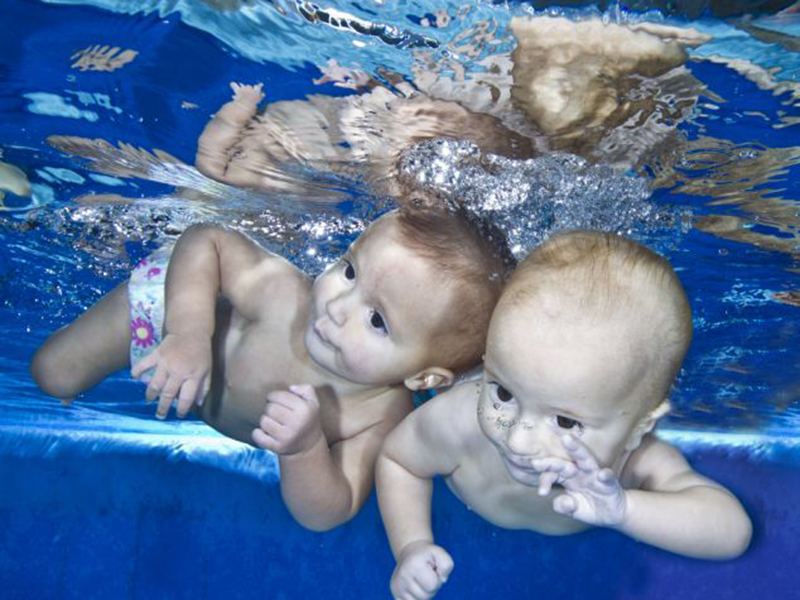 Bebeluşii acvatici! Faceţi cunoştinţă cu gemenii care sunt prea mici să meargă sau să vorbească, dar care înoată 25 m în piscină!