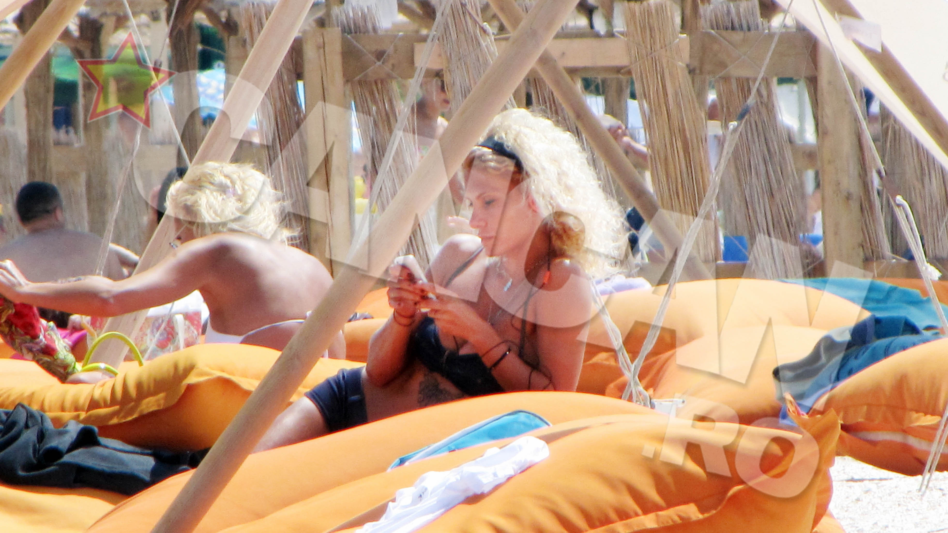 Cand valurile si vantul devin deranjante, blonda cu zulufi se asaza pe saltea, cu castile in urechi.