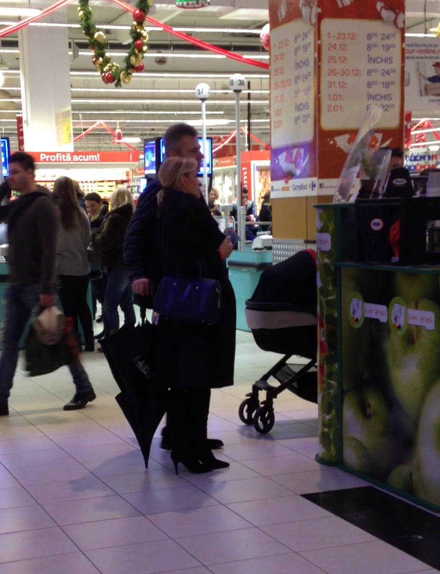 Gabi Firea se uita dupa produsele de care are nevoie. Burtica viitoarei mamici iese in evidenta