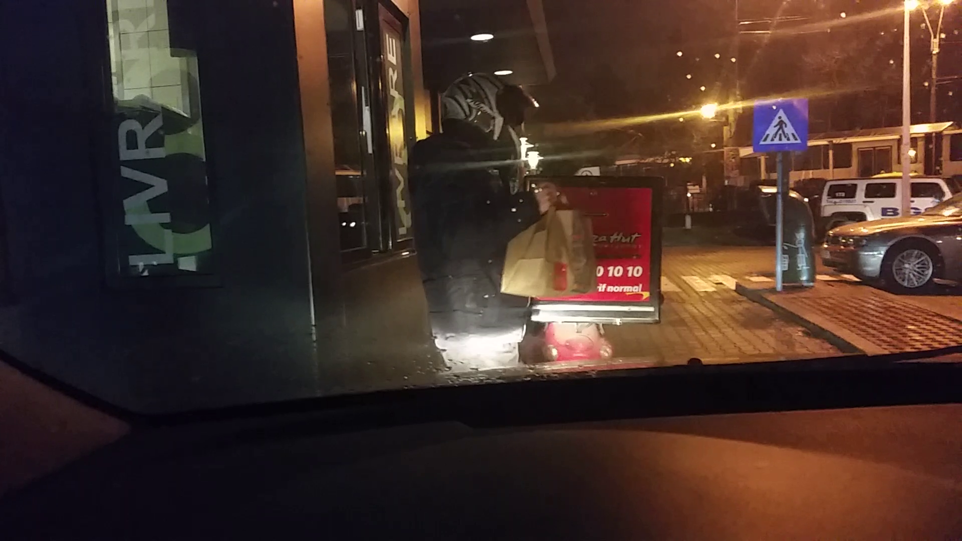 Dupa ce si-a luat produsele, le-a bagat in compartimentul special pentru pizza de pe scuter