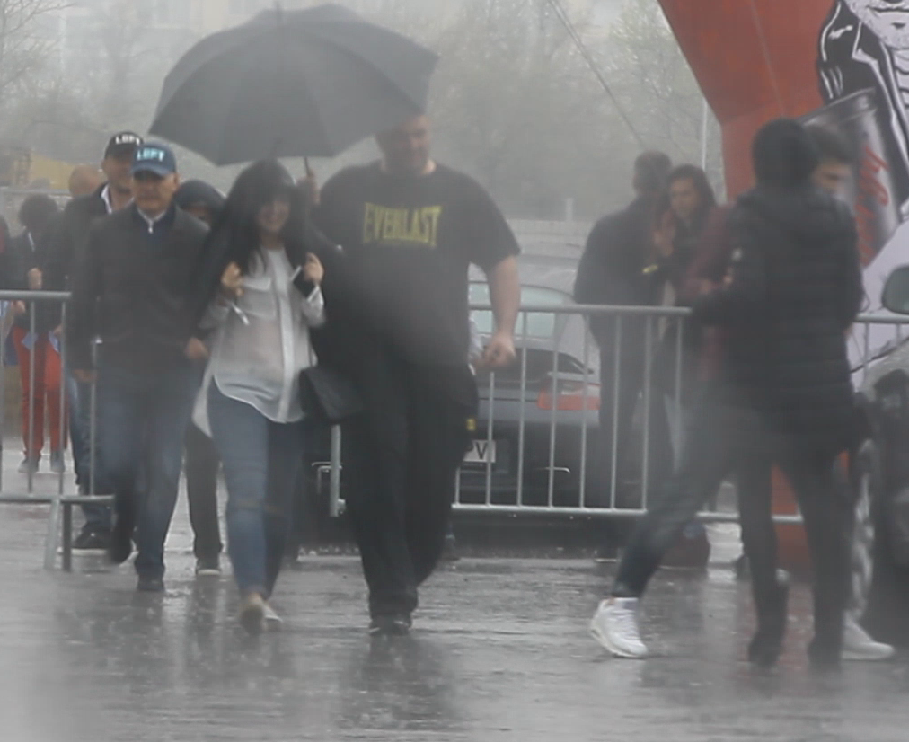 Pentru a nu fi udate de ploaie, bodyguardul le-a adus pe rand pe fetele lui Gigi la masina